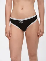 Colaless de algodón color celeste con ribete de encaje blanco y moño blanco en el frente.