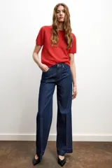 Jeans de tiro alto con diseño de cinco bolsillos, corte recto y raya planchada en el delantero y la espalda. Cierre frontal con cremallera y botón.