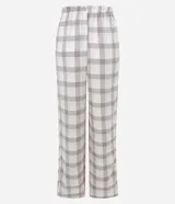 Pantalón de pijama Lov de corte holgado, confeccionado en franela de algodón. Presenta un estampado de cuadros en tonos beige y blanco, con cintura elástica y cordón de ajuste frontal.