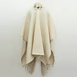 Capa azul de lana merino afieltrada, con guarda tejida en cuello y ruedo. Se puede usar como poncho o como capa abierta.