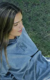 Buzo tipo canguro oversize de plush color verde militar, con capucha, mangas abullonadas con puños elásticos, bolsillo frontal tipo parche y cordón de ajuste en el ruedo. Presenta bordado en el pecho.