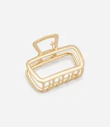 Pinza para el pelo dorada, mediana, con forma rectangular y diseño geométrico.