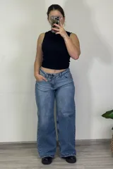 Pantalón jean celeste de tiro medio, corte ancho y estilo baggy.