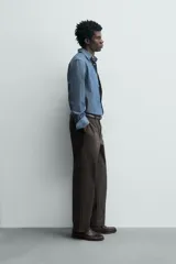 Pantalón de corte recto confeccionado en tejido compacto de algodón con estructura twill. Presenta cierre frontal con cremallera y botón, bolsillos laterales y bolsillos traseros de vivo con botón.