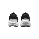 Championes Nike Uplift SC, color negro con detalles en blanco y gris. Presentan una parte superior de textil transpirable, entresuela de espuma para amortiguación y suela de goma para tracción.