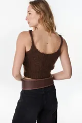 Faja ancha de cuero marrón chocolate con costuras decorativas contrastantes, cierre de nudo envolvente y trabilla lateral. Lleva la marca Petra grabada.