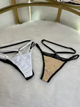 Pack de tres tangas Gaia de lycra y encaje con tiras regulables. Colores: negro, tostado y blanco.