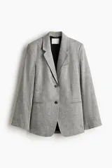 Blazer gris jaspeado de corte oversize, con botonadura sencilla de un botón, solapas de muesca, hombreras y forro interior negro.