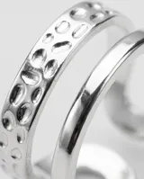 Set de tres anillos de acero con acabado texturizado y diseño ajustable.