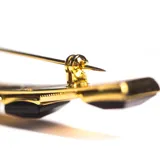 Broche dorado vintage con cinco apliques de resina negra.