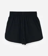Short deportivo modelo runner de Ashua, confeccionado en poliamida con tecnología dry de secado rápido. Presenta un diseño holgado con cintura elástica, bajos redondeados con vivos laterales en contraste y detalle de lettering en el ruedo.