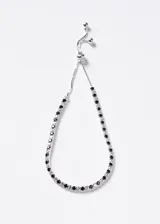 Pulsera de plata 925 modelo Grand Tennis Slider, con diseño ajustable y circones cúbicos intercalados en color blanco y negro.