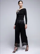 Pantalón negro de razo con terminación en encaje.