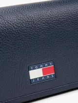 Bandolera Tommy Jeans azul marino con correa ajustable, cierre con solapa y logo de la marca en el frente.