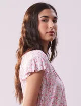 Conjunto de pijama de short y remera en tejido soft estampado. Remera de escote en V con aplique de puntilla, botones y detalle plisado. Short con cintura elastizada.