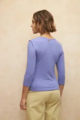 Remera negra de manga tres cuartos, cuello redondo y costuras marcadas en los hombros.