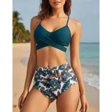 Conjunto de bikini de dos piezas de la marca Uniteduy, compuesto por un crop top amarillo liso con diseño cruzado y tirantes finos, y una bombacha de tiro alto con estampado floral y de hojas en tonos amarillos, verdes y blancos.