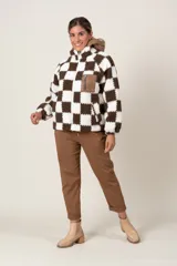 Campera símil corderito a cuadros marrones y blancos, con cierre frontal y bolsillos laterales. Capucha y bolsillo frontal con cierre de nylon color marrón.