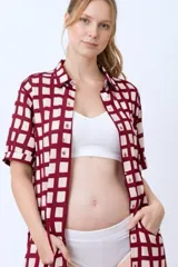 Camisa maternal de viscosa suave y liviana, con estampado de cuadros irregulares en color bordó y beige. Presenta cuello camisero, mangas cortas con dobladillo y bolsillos frontales.
