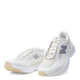 Championes New Balance modelo Training Cat, de diseño deportivo en tonos blanco y beige con detalles en lila. Presentan una estructura de malla transpirable con refuerzos sintéticos, el logo 'N' característico en el lateral y una suela de goma con amortiguación.