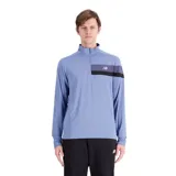 Buzo deportivo celeste de manga larga con cierre medio en el cuello. Presenta una franja horizontal en el pecho con el logo de la marca.