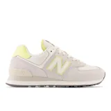 Championes urbanos New Balance modelo 574, color blanco hueso con detalles en amarillo, confeccionados en gamuza y malla, con logo "N" característico en los laterales y entresuela ENCAP.