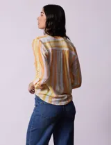 Blusa estampada de Zac & Rachel con cuello a la base, escote en V y botones. Tiene un bolsillo aplicado en la parte delantera, mangas largas regulables con presilla y botón, y terminación anudada opcional.