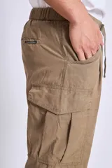 Pantalón cargo color beige con cintura ajustable con cordón y bolsillos laterales con solapa.