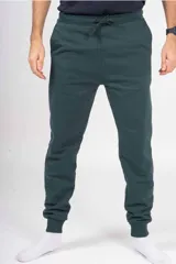 Pantalón de jogging unisex de felpa, color verde oscuro, con cintura elástica con cordón de ajuste y puños elásticos en los tobillos.
