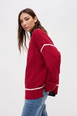 Buzo de punto tejido en algodón, con diseño de ochos y detalles en color blanco en sisas y ruedo. Presenta cuello redondo y calce holgado.