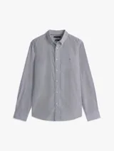 Camisa de manga larga Tommy Hilfiger con diseño de rayas clásicas, cuello abotonado y cierre frontal de botones. Cuenta con el logo bordado en el pecho.