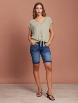 Blusa color beige de modal con escote en V, abertura central con botones y ruedo anudado. Marca French Laundry.