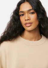 Buzo de punto negro con cuello redondo acanalado, mangas largas con puños ajustados y diseño holgado.
