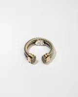 Anillo abierto de plata 925 con doble banda trenzada y apliques dorados con circonias blancas.