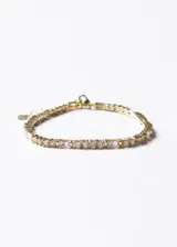 Pulsera de plata 925 con baño de oro 18k y zirconias incrustadas en cortes alternados.