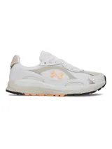 Championes deportivos Under Armour modelo Tech Runner, con diseño de perfil bajo. Presentan una parte superior de malla transpirable en color blanco con superposiciones de cuero y gamuza en tonos beige. Incluyen detalles en color naranja, destacando el logotipo de la marca en el lateral, y una entresuela de EVA acolchada con suela de goma.