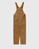 Mameluco Carhartt WIP modelo Bib Overall, de color negro, con múltiples bolsillos frontales, tirantes ajustables con hebillas metálicas y el parche con el logotipo de la marca en el bolsillo del peto.