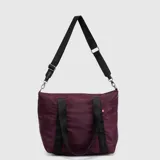 Bolso tipo tote de la marca Bubba, color azul petróleo, con cierre superior, doble asa de mano y correa larga ajustable y extraíble. Presenta detalles de cintas negras con el logo de la marca y una pequeña etiqueta lateral.