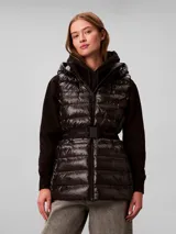 Chaleco puffer liviano marca Calvin Klein color negro, con diseño acolchado, capucha, cierre frontal y cinturón elástico con hebilla a presión y logo de la marca.