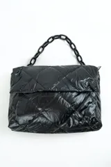 Cartera acolchada negra de material sintético con efecto brillante y costuras en rombos. Cuenta con solapa frontal y una correa corta de cadena gruesa de eslabones plásticos negros.