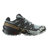 Championes de trail running Salomon Speedcross 6 Gore-Tex, en color gris y negro con detalles en dorado. Incorporan membrana impermeable y transpirable, suela Contagrip de gran adherencia y sistema de ajuste rápido de cordones Quicklace.