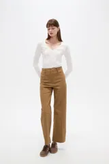 Pantalón de algodón color blanco, de tiro alto y corte flare, con bolsillos y detalles de vivos.