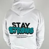 Canguro blanco oversize de algodón con felpa, con capucha y cordón ajustable. Estampa en la espalda con la frase "Stay Strong" en negro y turquesa, y texto inferior con la marca "Duxon Originals".