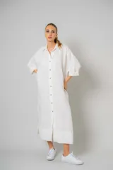 Vestido camisero blanco de lino, largo midi, con cuello camisero, mangas 3/4 y cierre frontal con botones.