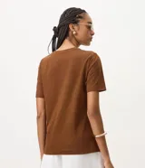 Remera de algodón marrón de manga corta y cuello redondo, con apliques tridimensionales de flores en relieve en el frente.