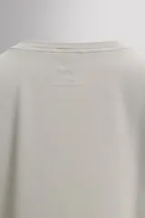 Musculosa de entrenamiento Zara Athleticz, confeccionada en tejido técnico ligero y elástico con zonas perforadas para mayor transpirabilidad. Presenta cuello redondo, corte regular fit y detalle de logo estampado en el pecho y el ruedo.