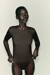 Body de manga larga confeccionado en mezcla de poliamida, con cuello redondo y cierre inferior con botones a presión.