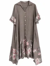 Vestido midi color visón con cierre frontal de botones, cuello camisero, mangas cortas con volados y detalles de tela estampada floral en mangas y dobladillo inferior.