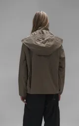 Campera técnica liviana color beige, confeccionada en microfibra de alta densidad con acabado mate. Presenta mangas desmontables que permiten convertirla en chaleco, cuello tipo camisa, cierre frontal oculto bajo cartera y logo bordado en el pecho. Incluye cuatro bolsillos frontales de gran tamaño con solapa y puños con elástico.