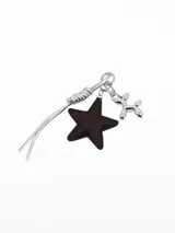 Llavero de metal plateado con dije de estrella de cuero marrón y dije en forma de perro de globo, con tira decorativa de cordones plateados.